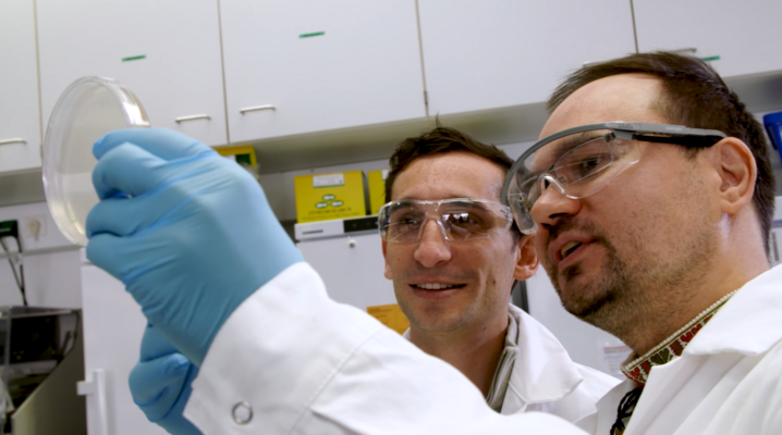 Film still with Chase Beisel and Oleg Dmytrenko in the HIRI lab